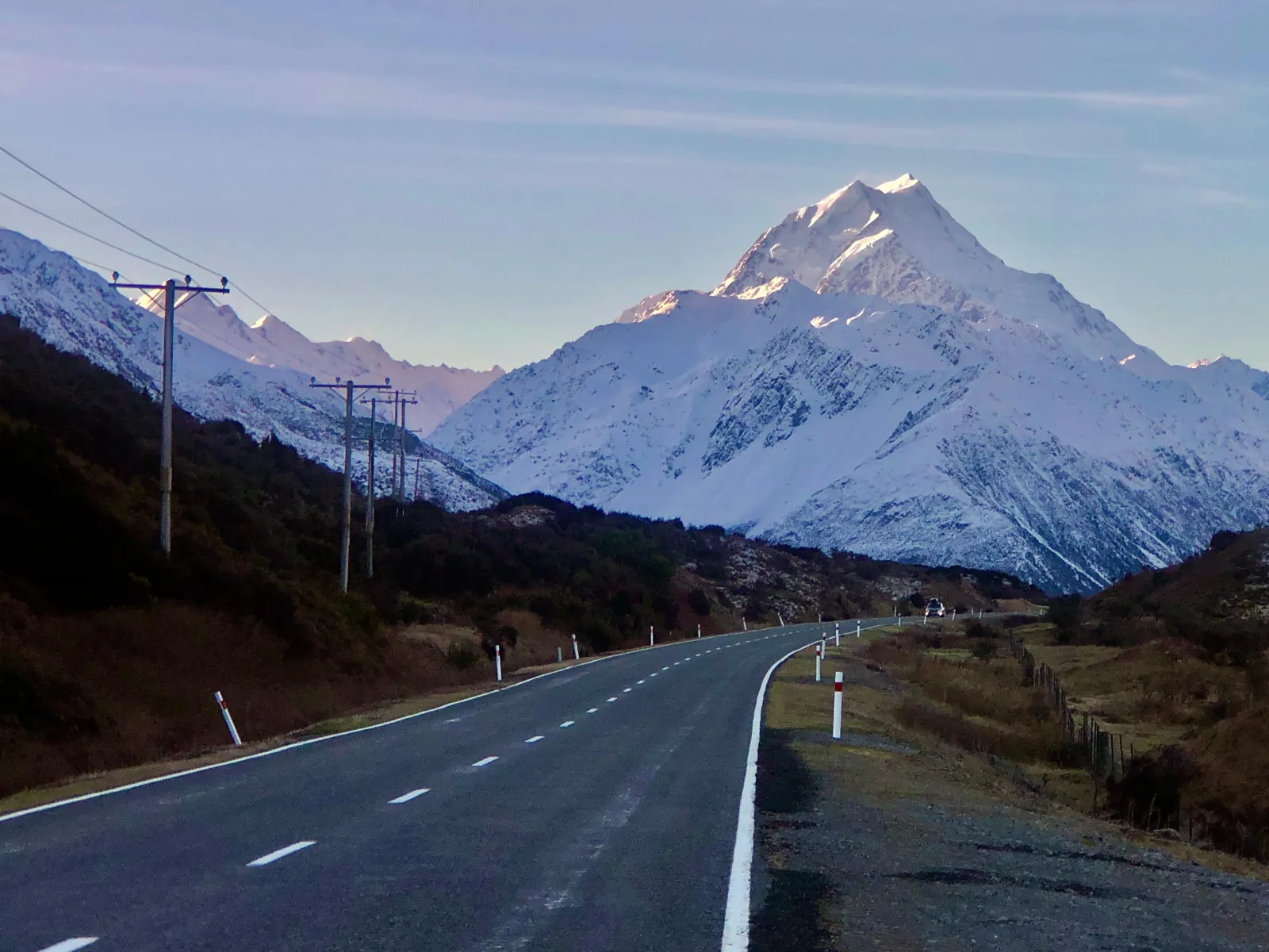 State Highway 80 leading toward snow-covered Aoraki/Mount Cook in early morning light